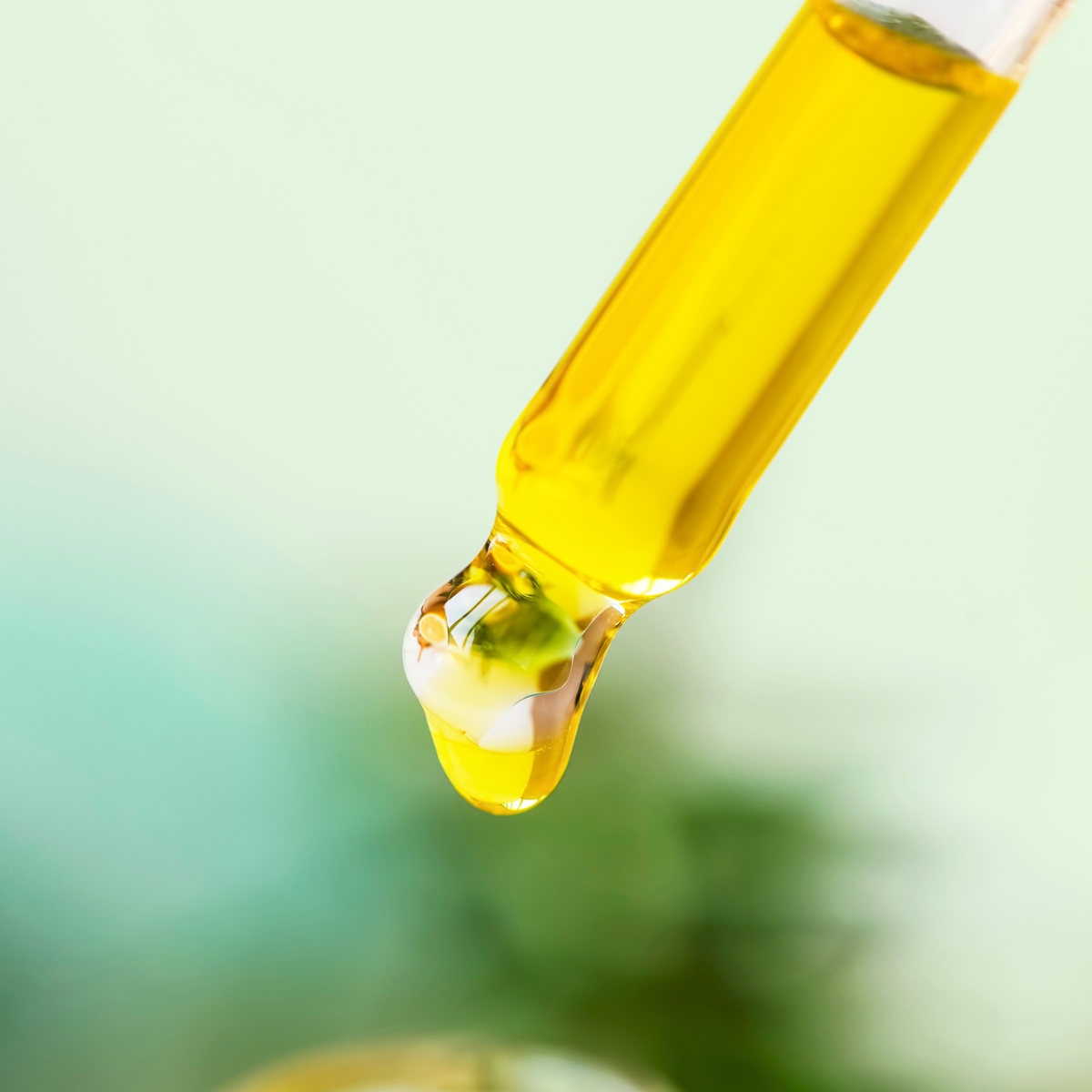 Island Refresh Smoothing Serum drop from a glass dropper